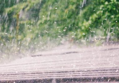 summer rain with hail falls on the roof of slate