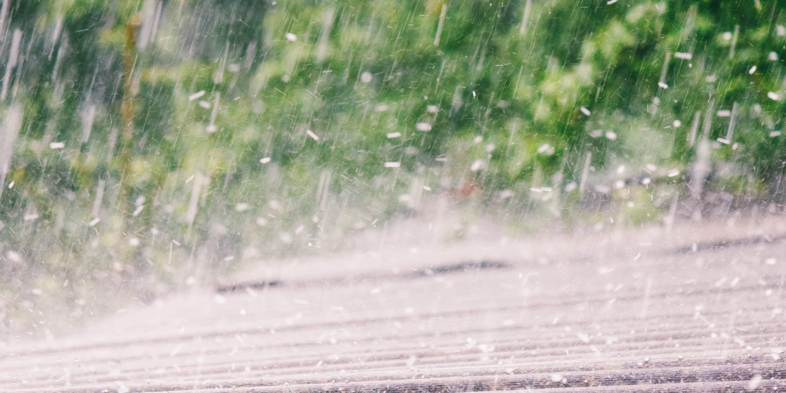 summer rain with hail falls on the roof of slate
