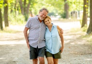 Happy beautiful senior couple in love walking and holding hands in the park enjoying life outdoors. Happy and active retirement concept