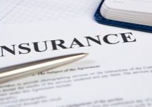 Closeup the silver ballpoint modern pen on insurance contract with planning in background.