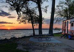 Travel trailer camping at sunset by the Mississippi river in Illinois at sunset panorama