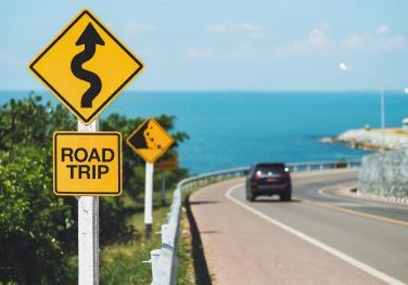 road trip word and curvy road sign